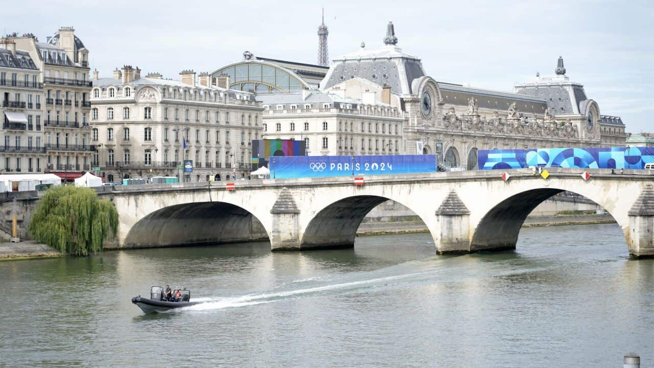 The Seine River and a bridge with Paris 2024 banners on it.