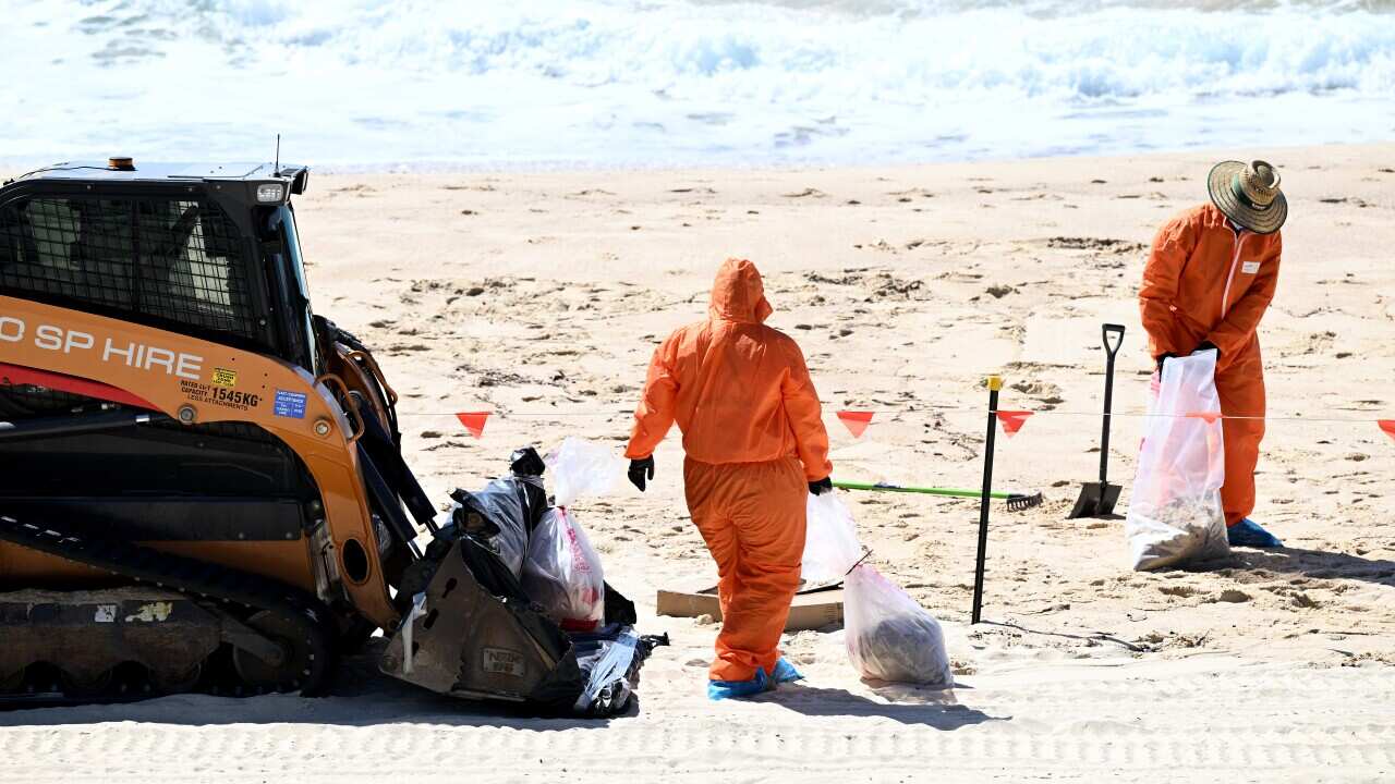 Sydney’s beaches reopen but the “tar ball” mystery remains.