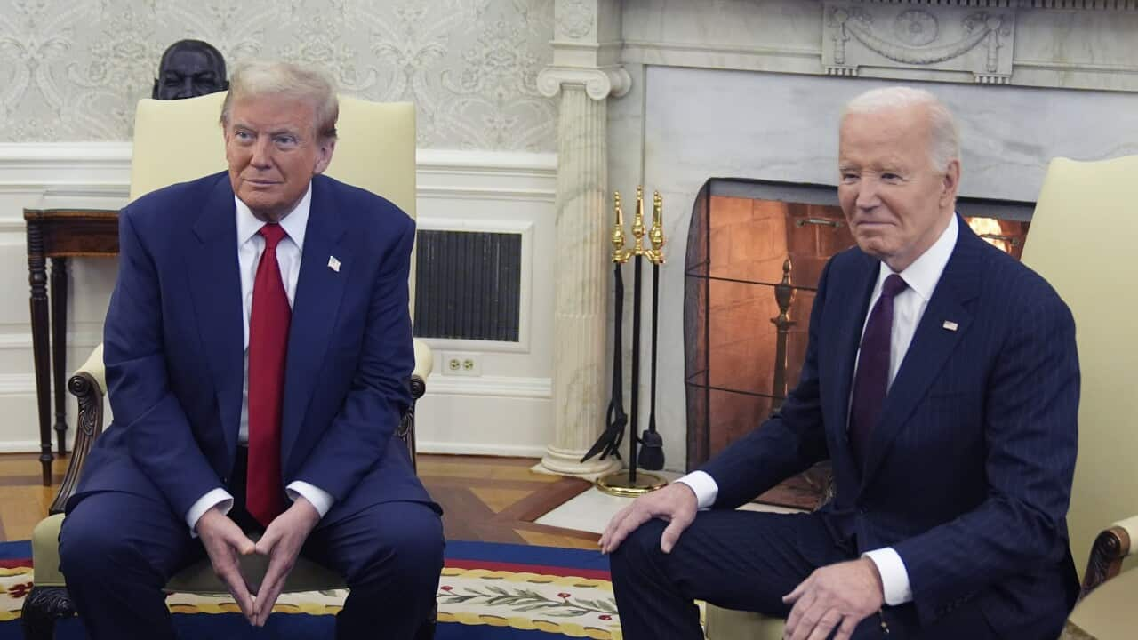 Donald Trump (L) sitting next to Joe Biden (R).