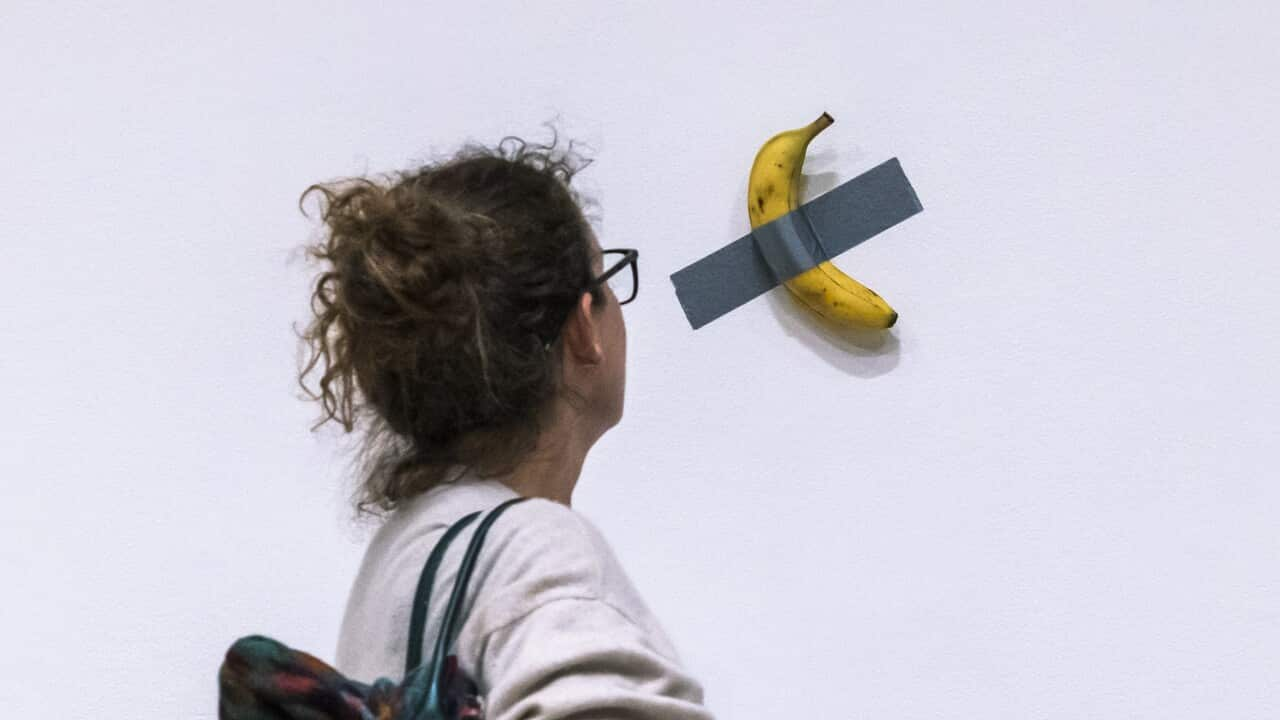 A banana taped to a wall sells for nearly $10 million at a New York auction