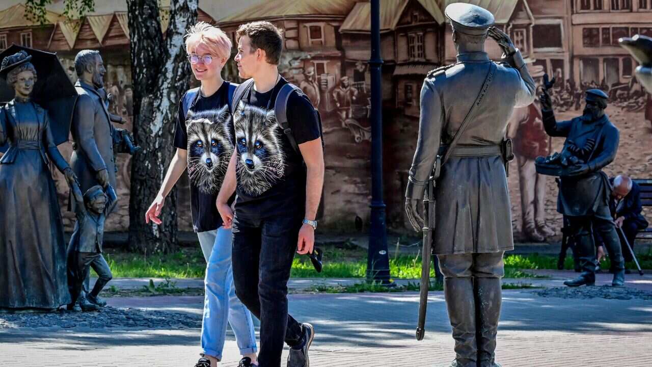 A couple walking in a park holding hands