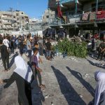 People looking at destroyed buildings