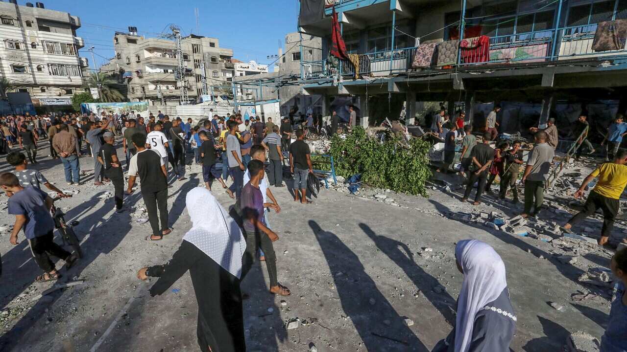 People looking at destroyed buildings