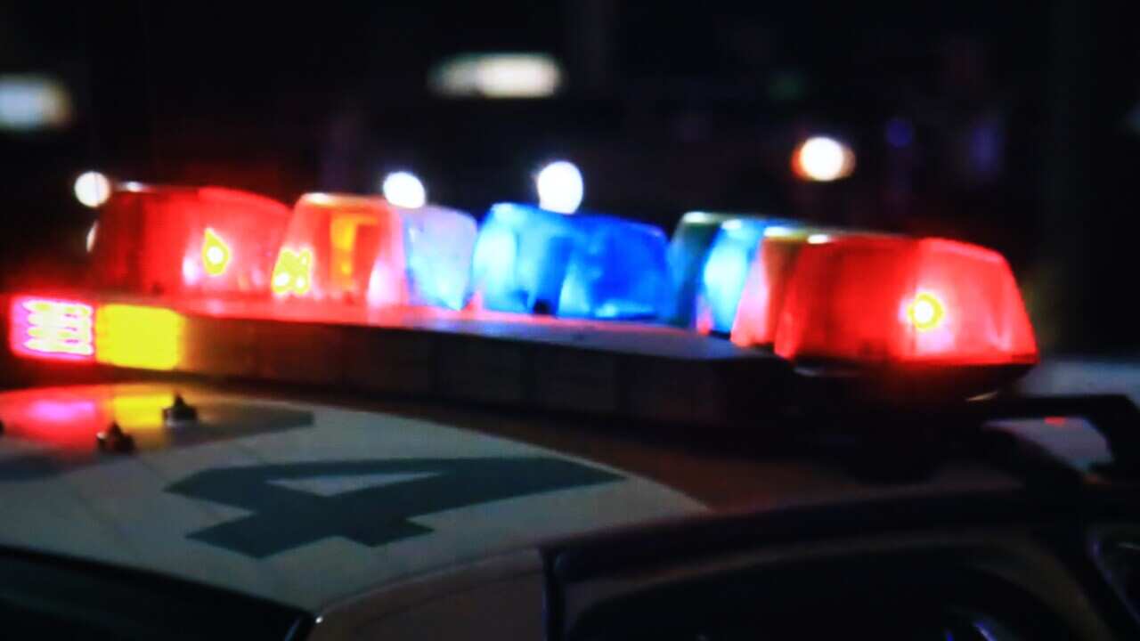 The roof of a police car, with flashing blue and red lights.